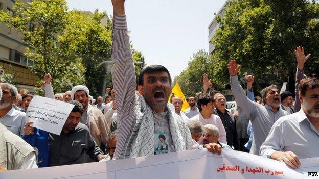 Iranian Islamists shout slogans during a protest against allowing women to sporting stadiums