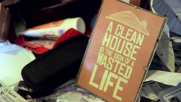 Poster reading 'A clean house is the sign of a wasted life'