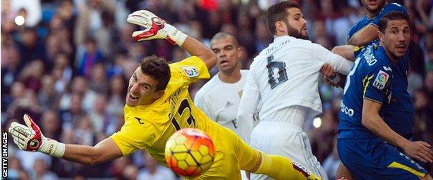 Getafe's goalkeeper Vicente Guaita dives for the ball during his side's 4-1 defeat at Real Madrid