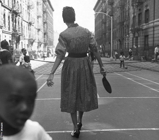 Gibson playing paddle tennis in the streets of Harlem