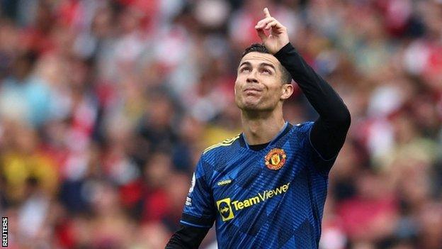 Cristiano Ronaldo points to the sky after scoring against Arsenal