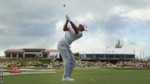 Tiger Woods takes a shot on the 18th at the Hero World Challenge