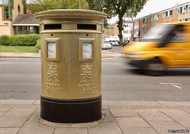 A gold painted post box in Isleworth