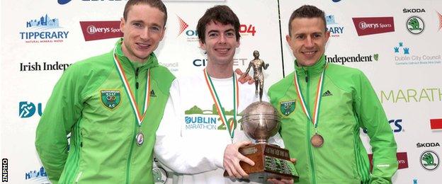 Paul Pollock (centre) with the Irish Marathon trophy after finishing ahead of compatriots Sean Hehir (left) and Barry Minnock at the 2012 Dublin Marathon