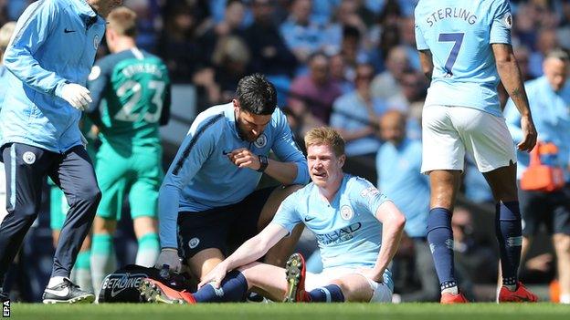 Kevin de Bruyne sitting on the pitch at Etihad Stadium