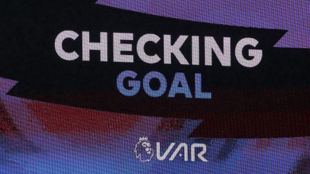 A screen announcing VAR decision