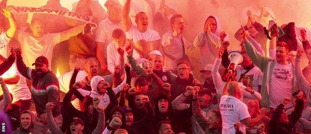 Legia fans let of flares during the second half at Ibrox