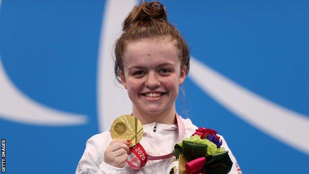 Maisie Summers-Newton shows off her gold medal in the S6 200m medley