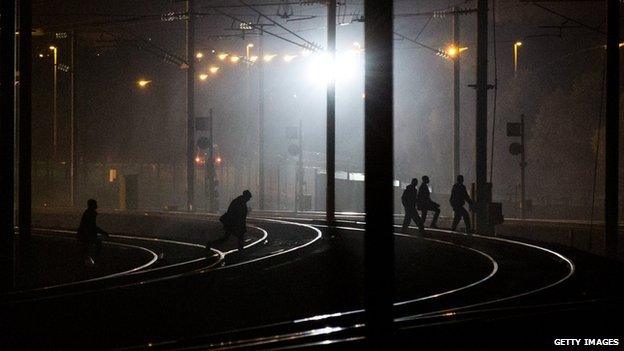 Migrants on tracks near the Eurotunnel terminal in France