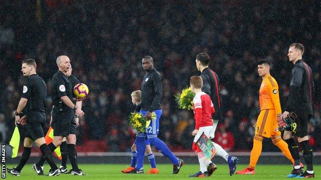 Sol Bamba led Cardiff City out carrying daffodils in tribute to missing striker Emiliano Sala