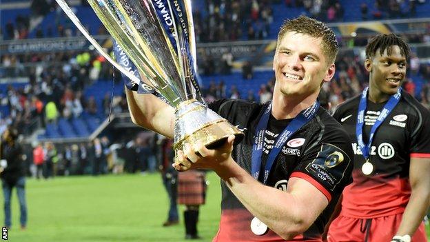 A smiling Owen Farrell holds aloft the Champions Cup trophy