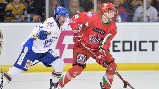 Andrew Hotham takes the puck forward for the Devils