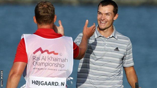 Nicolai Hojgaard celebrates winning the Ras al Khaimah Championship with his caddie