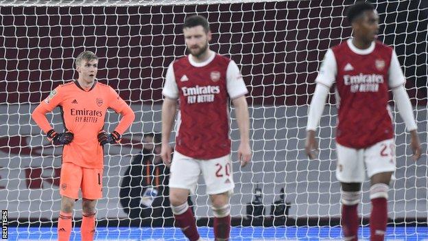 Arsenal's players reacts during their team's 4-1 defeat to Manchester City in the Carabao Cup