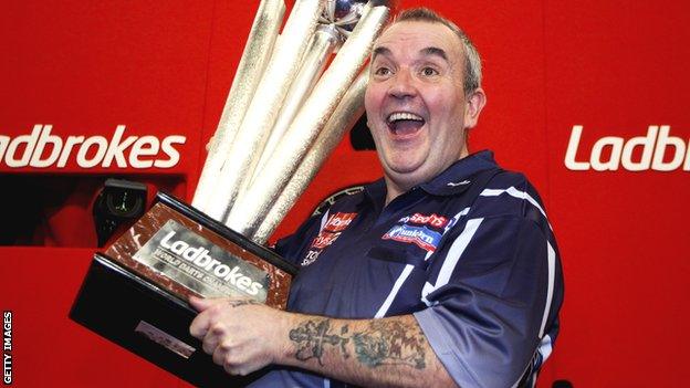 Phil Taylor lifts the Sid Waddell Trophy