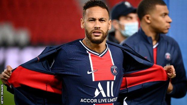 Neymar and Kylian Mbappe watch on during a Ligue 1 game