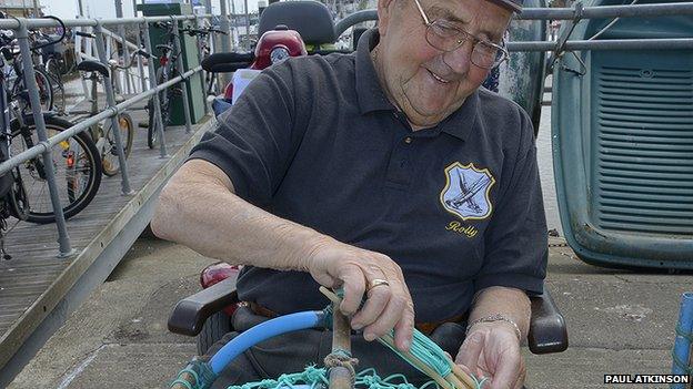 Fisherman making lobster pots