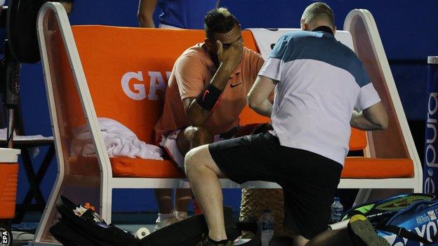 Nick Kyrgios looking dejected while receiving treatment on his left wrist during a medical timeout at the Mexican Open