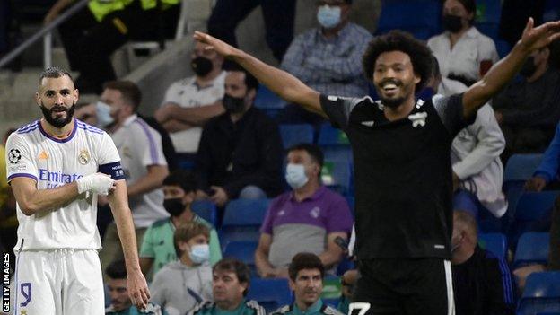 Real Madrid's French forward Karim Benzema looks at the celebration of Sheriff's Brazilian midfielder Bruno Felipe Souza da Silva