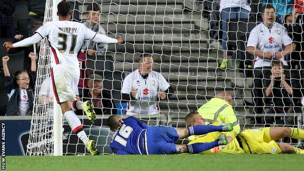 Josh Murphy of MK Dons slots home the winning extra-time goal