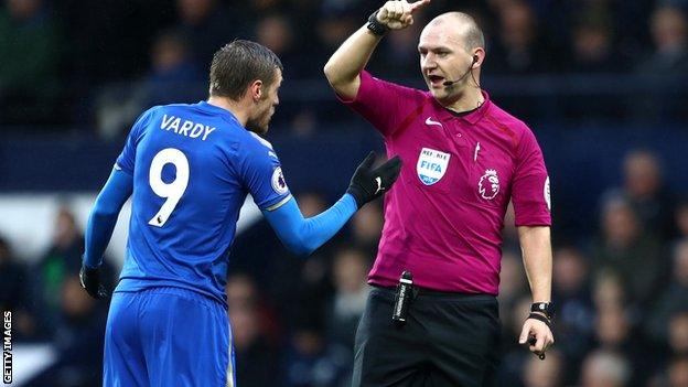 Bobby Madley speaks to Leicester striker Jamie Vardy