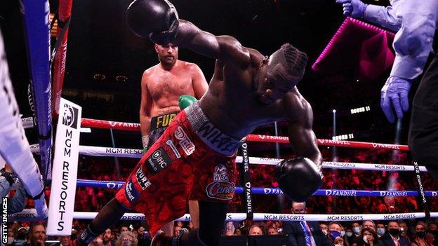 Deontay Wilder falls to the ground