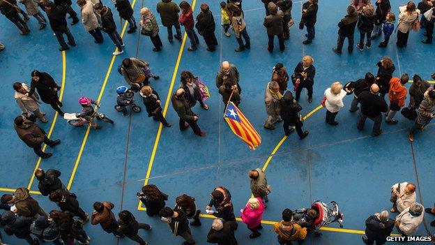 People wait for their turn to cast their vote at a polling station on November 9, 2014 in Barcelona, Spain. Catalans vote today during an unofficial and non-binding consultation on independence of Catalonia from Spain.