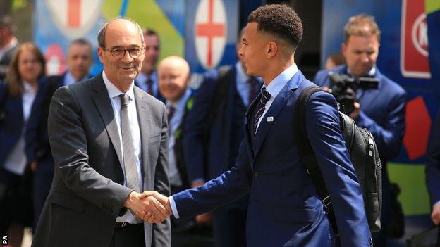 Tottenham player Dele Alli is greeted by the Mayor of Chantilly, Eric Woerth