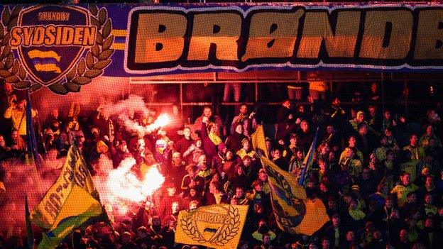 Brondby fans light flares during their match against Rangers