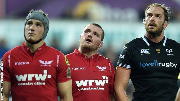 Jonathan Davies, Ken Owens and Alun Wyn Jones look up at a big screen during a Scarlets v Ospreys match