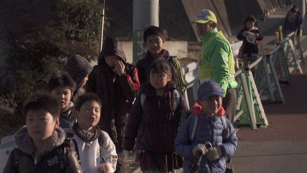 Lollipop man at school crossing