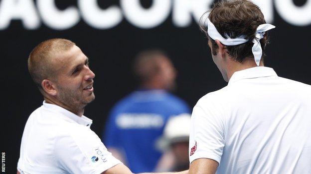 Dan Evans shakes hands with Roger Federer