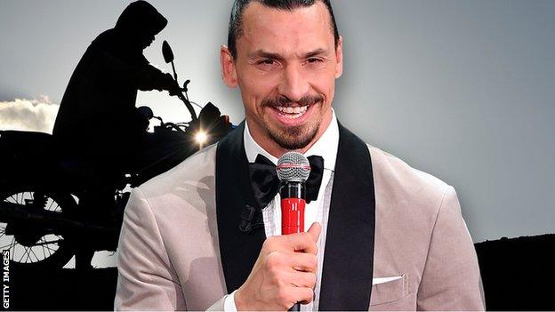 Zlatan Ibrahimovic in dinner jacket with microphone. Motorbike in background.