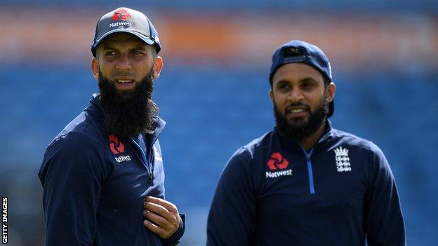 England all-rounders Moeen Ali and Adil Rashid look on during a training session