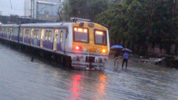 A Mumbai train lying on flooded rail tracks