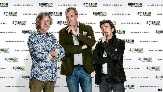 James May, Jeremy Clarkson and Richard Hammond in front of Amazon Prime backdrop