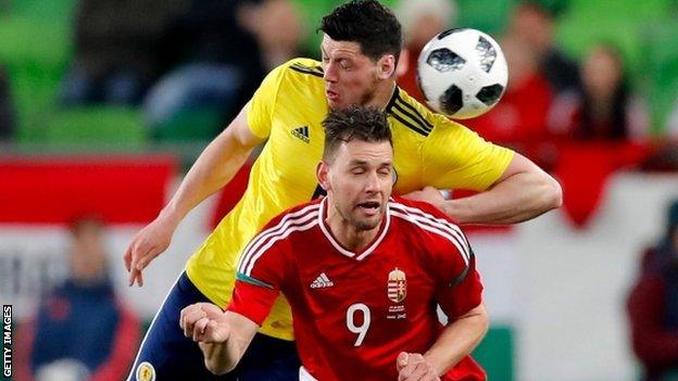 Scott McKenna competes for a header with Hungary's Adam Szalai