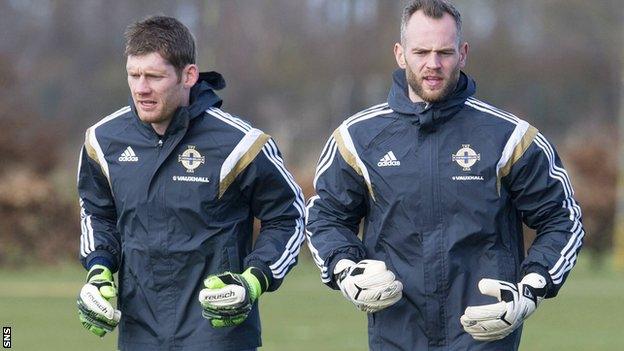 Mannus (right) has been involved with the Northern Ireland squad for 13 years, winning eight caps