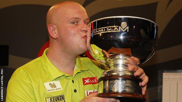 Michael van Gerwen kisses the Grand Slam of Darts trophy