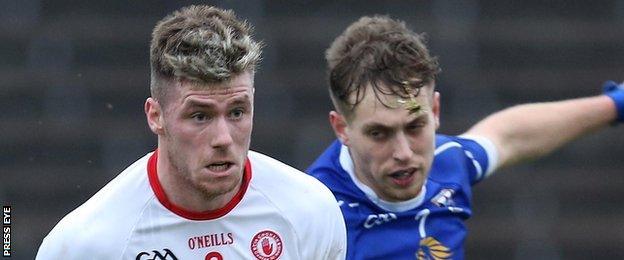 Tyrone's Declan McClure in action against Padraig Faulkner of Cavan