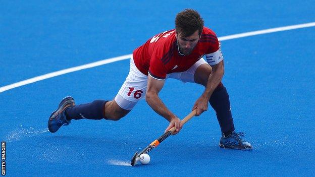 Great Britain men's hockey captain Adam Dixon prepares to pass the ball