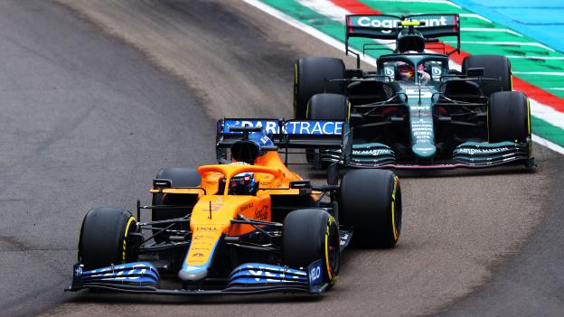 Sebastian Vettel in the Aston Martin behind McLaren's Daniel Ricciardo