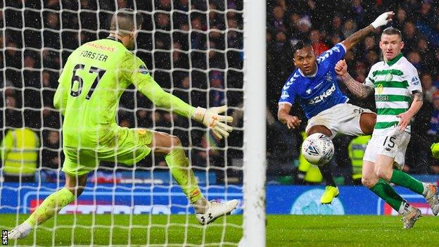 Rangers' Alfredo Morelos fires wide of Celtic's Fraser Forster