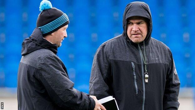 Glasgow Warriors coach Dave Rennie (right) takes training in the rain