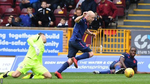 Hearts' Steven Naismith scored after Uche Izpeaku and Motherwell goalkeeper Trevor Carson challenged for the ball