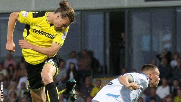 Burton's Jackson Ivine scores with a header against Sheffield Wedneday