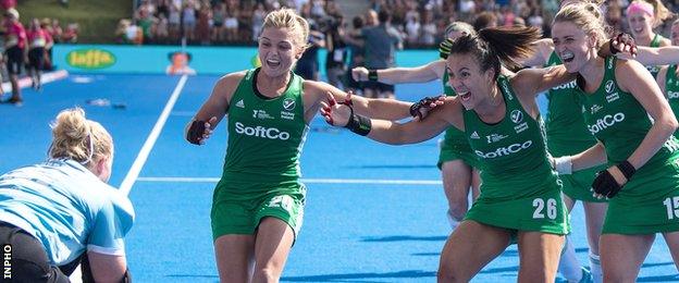 Chloe Watkins, Anna O'Flanagan and Gillian Pinder rush to celebrate with with goalkeeper Ayeisha McFerran