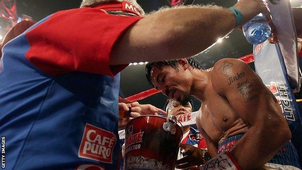 Manny Pacquiao spits into a bucket