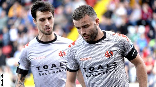 Declan Caddell congratulates Crusaders goal-scorer Colin Coates