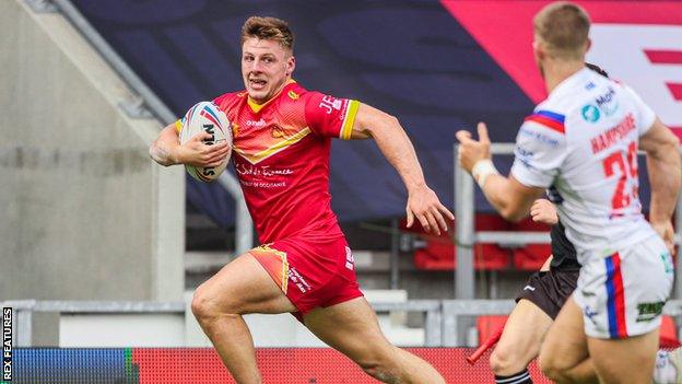 Catalans' Tom Davies goes over for a try against Wakefield